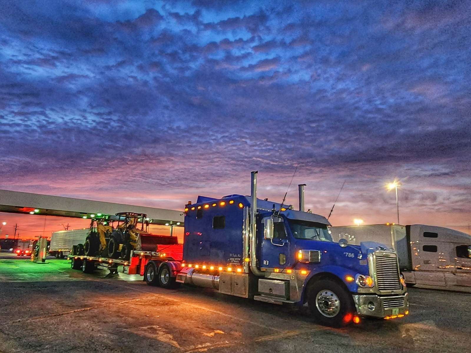 Stepdeck trailer hauling equipment in Southwest Florida
